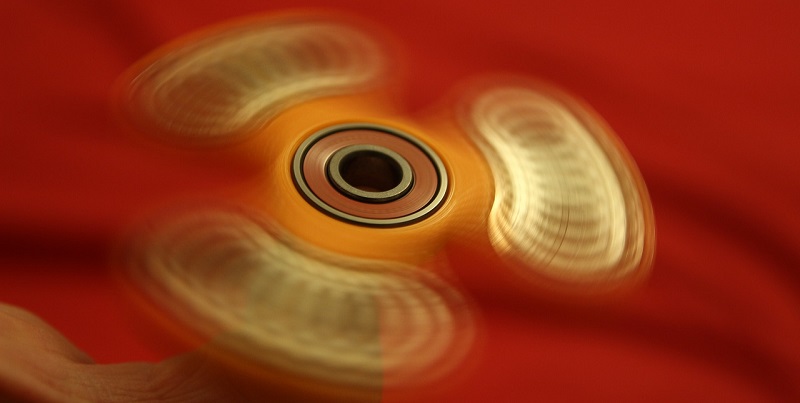 The Physics of Fidget Spinners: Explaining the Moment of Inertia