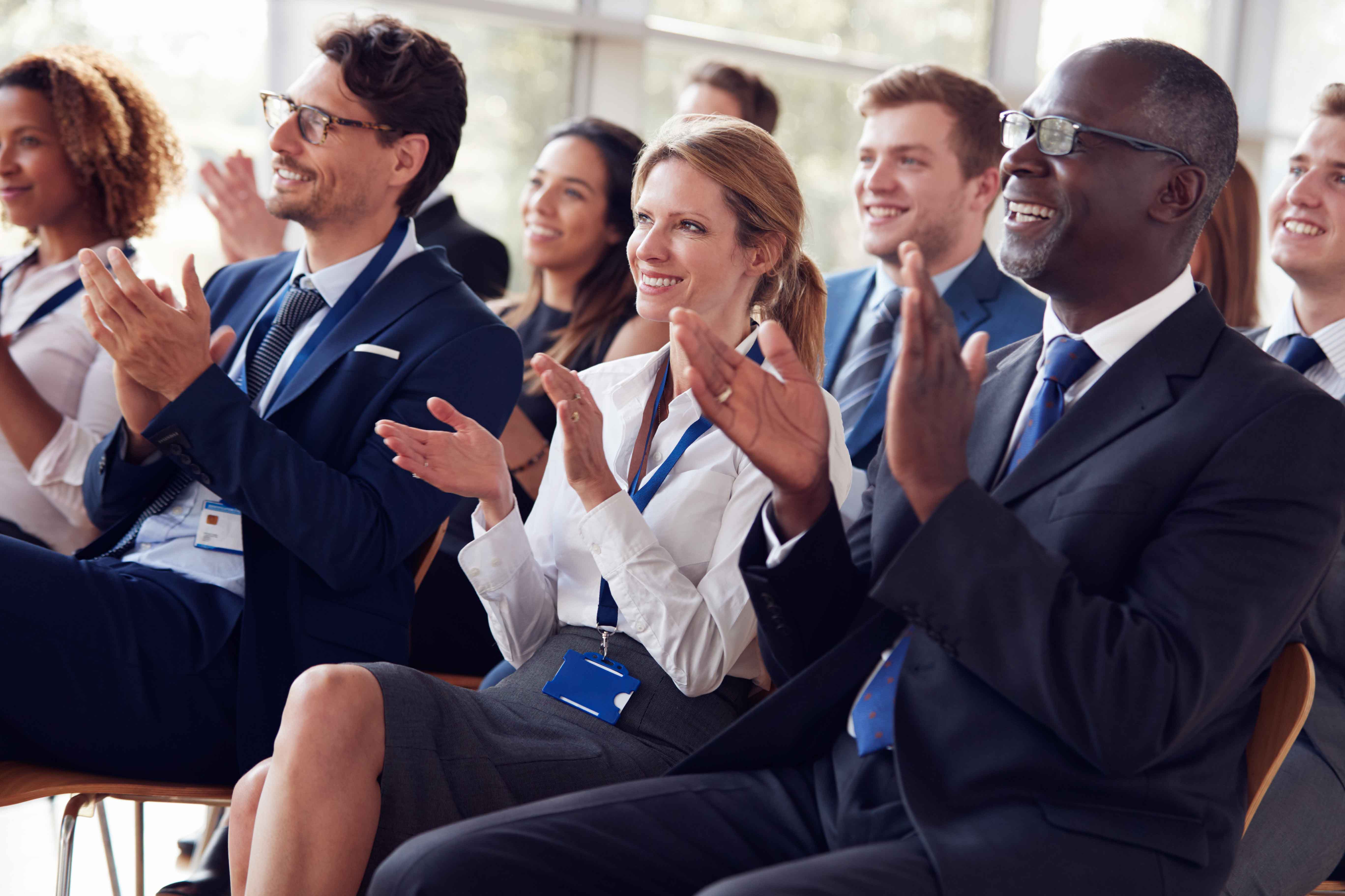 Audience at a conference clapping